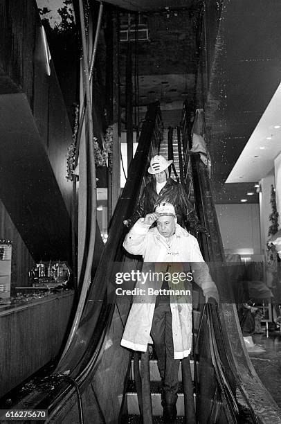 Neiman Marcus president Stanley Marcus and Dallas Fire Chief C.N. Penn inspect damage to the world-famed Neiman Marcus specialty store here after a...