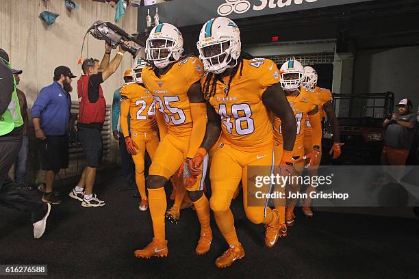 Walt Aikens and MarQueis Gray of the Miami Dolphins take the field for the game against the Cincinnati Bengals at Paul Brown Stadium on September 29,...