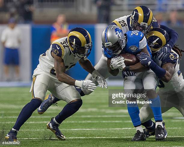 Strong safety T.J. McDonald, outside linebacker Mark Barron and cornerback Troy Hill of the Los Angeles Rams tackle running back Justin Forsett of...