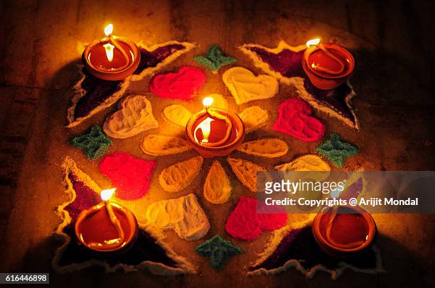 earthen lamps and rangoli decoration on floor for diwali festival - rangoli stock pictures, royalty-free photos & images