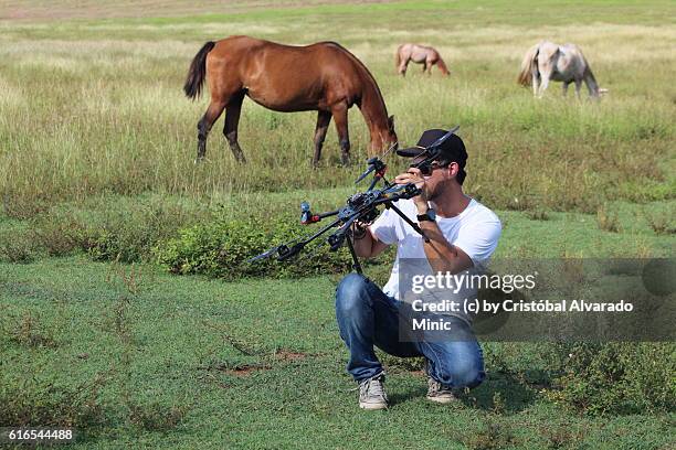 young businessman holds unmanned aerial vehicle (uav). - octocopter stock pictures, royalty-free photos & images