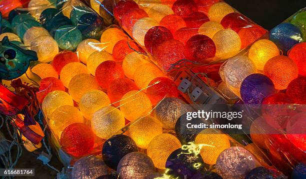 close-up of brightly lit yarn lanterns - lantern stock pictures, royalty-free photos & images