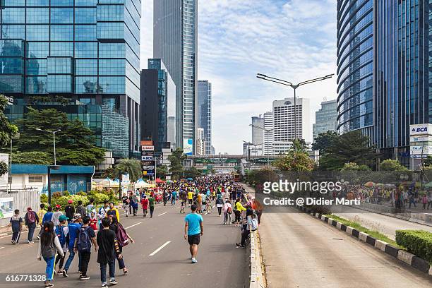 people walking on the streets of jakarta business district - jakarta stock pictures, royalty-free photos & images