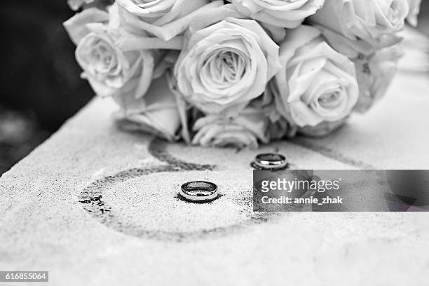 White and black flowers and rings on frozen surface