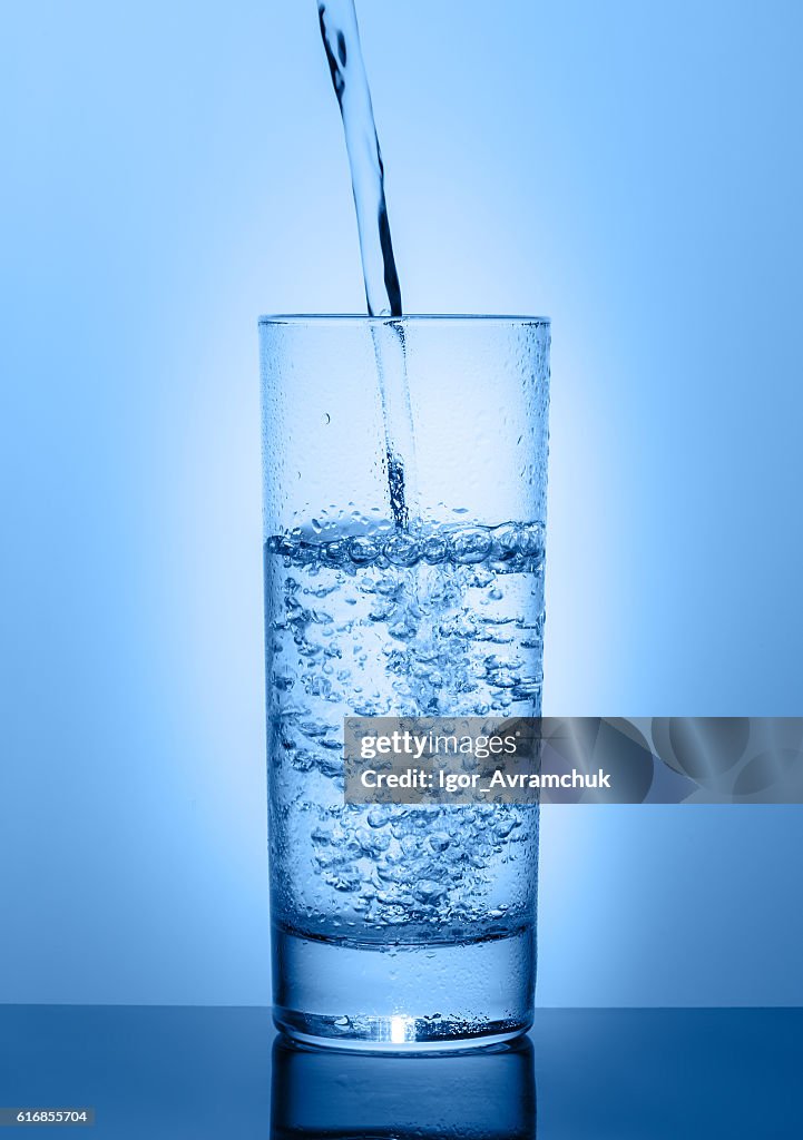 Beautiful glass with water on a blue background