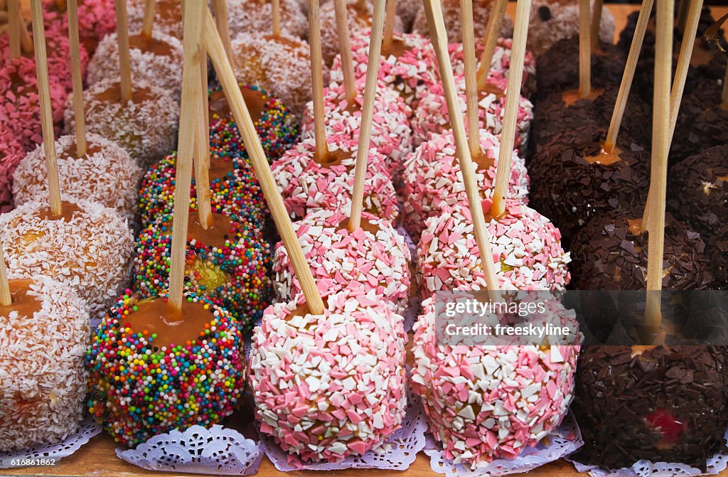 Hand dipped caramel apples in chocolate and nuts. Street food