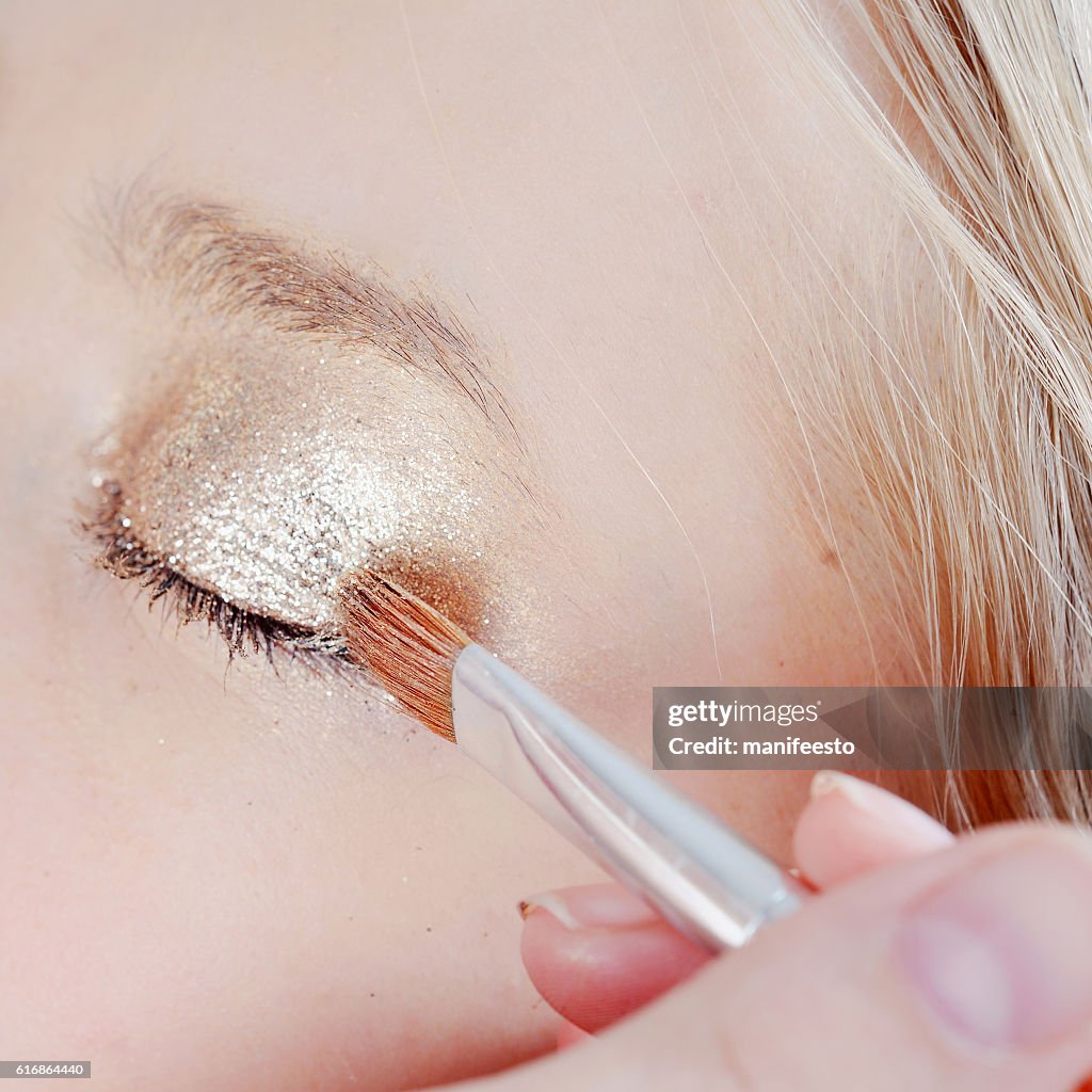 Eye makeup artist applying eyeshadow