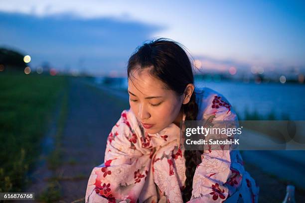 young yukata woman sitting nearby river - yukata stock pictures, royalty-free photos & images