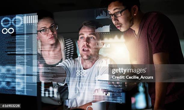 analysing the data - young businessman using a virtual screen stockfoto's en -beelden