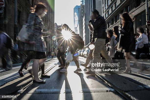 people on the street crossing in toronto, canada - crossing street stock pictures, royalty-free photos & images