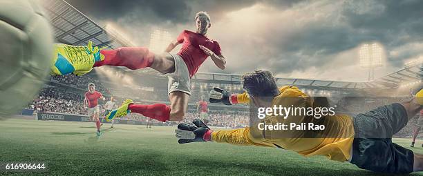 soccer player scores goal with volley kick in football match - dramatic sky perspective stock pictures, royalty-free photos & images
