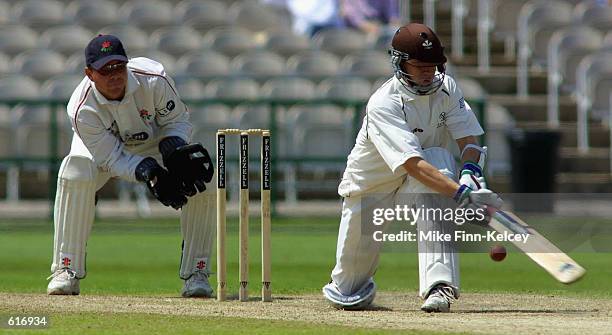 June 1: Warren Hegg of Lancashire looks on as Jonathan Batty of Surrey hits out on his way to 105 during the Frizzell County Championship match at...