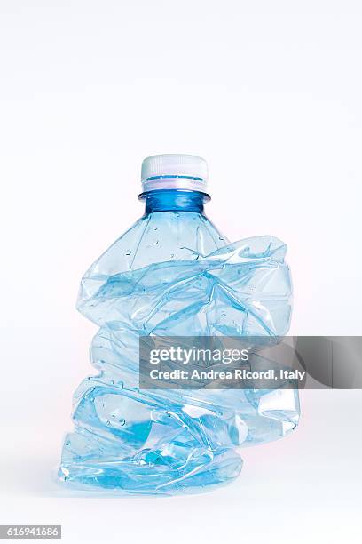 crushed plastic bottle to recycle - bottiglia foto e immagini stock