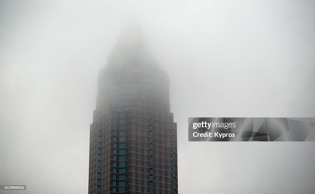 Europe, Germany, Frankfurt, View Of The The Messeturm Or Trade Fair Tower Office Building On Foggy Day. It Is A 257 Meter (843 Ft) Skyscraper With 63-Storeys, The Second Tallest Building In Germany And The Third Tallest Building In The European Union.