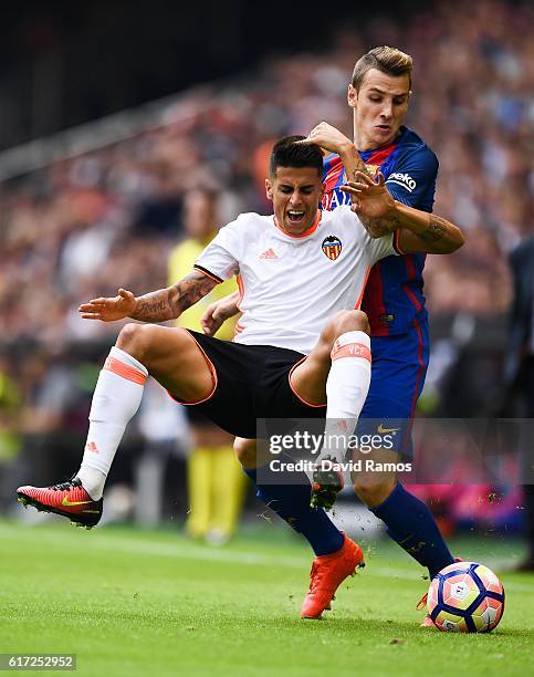 Joao Cancelo of Valencia CF is brought down by Lucas Digne of FC Barcelona during the La Liga match between Valencia CF and FC Barcelona at Mestalla...
