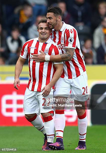 Xherdan Shaqiri of Stoke City celebrates scoring his sides first goal with Geoff Cameron of Stoke City during the Premier League match between Hull...