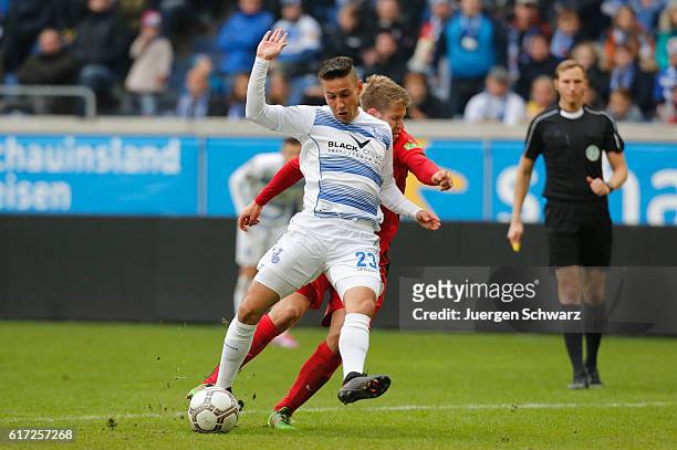Tommy Grupe of Rostock tackles Fabian Schnellhardt of Duisburg during the third league match between MSV Duisburg and Hansa Rostock at...