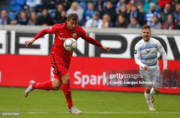 Marcel Ziemer of Rostock controls the ball beside Nico Klotz of Duisburg during the third league match between MSV Duisburg and Hansa Rostock at...