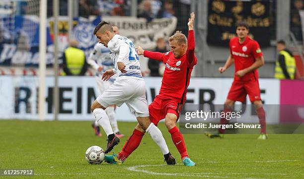 Fabian Schnellhardt of Duisburg tackles Tommy Grupe of Rostock during the third league match between MSV Duisburg and Hansa Rostock at...