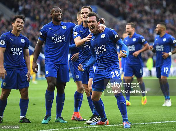 Christian Fuchs of Leicester City celebrates scoring his sides third goal with his Leicester City team mates during the Premier League match between...