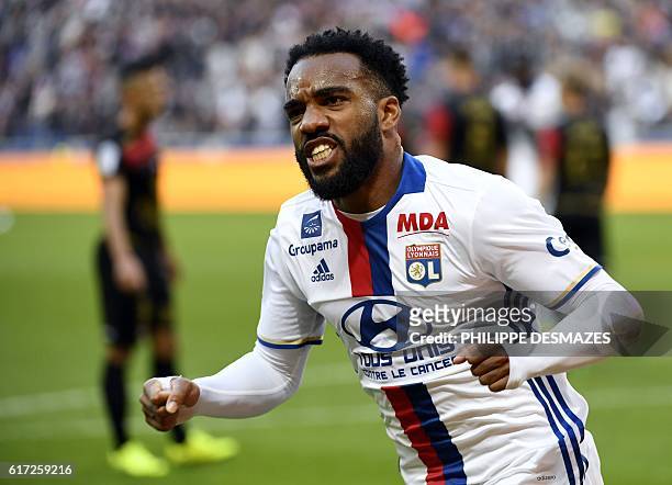 Lyon's French forward Alexandre Lacazette reacts after scoring a goal during the French L1 football match Olympique Lyonnais against EA Guingamp on...