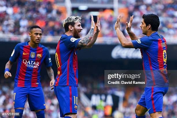 Luis Suarez of FC Barcelona celebrates with his team mates Neymar Jr. And Lionel after scoring his team's second goal during the La Liga match...