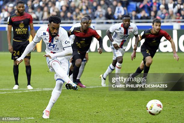 Lyon's French forward Alexandre Lacazette shoots a penalty and scores during the French L1 football match between Olympique Lyonnais and EA Guingamp...