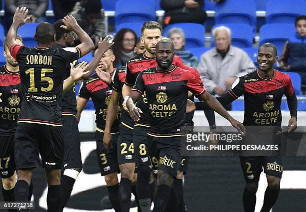 Guingamp's French midfielder Yannis Salibur celebrates with his teammate after scoring a goal during the French L1 football match between Olympique...