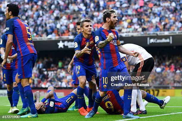 Lionel Messi of FC Barcelona celebrates with his team mates as Neymar Jr. And Luis Suarez reacts on the pitch after being hit by objects thrown from...