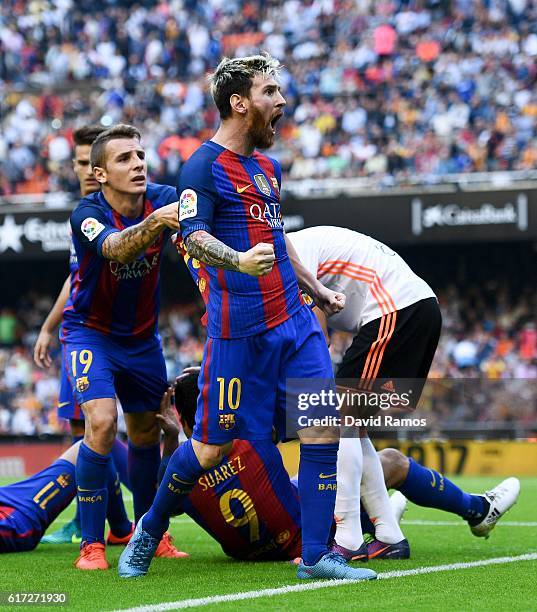 Lionel Messi of FC Barcelona celebrates with his team mates as Neymar Jr. And Luis Suarez reacts on the pitch after being hit by objects thrown from...