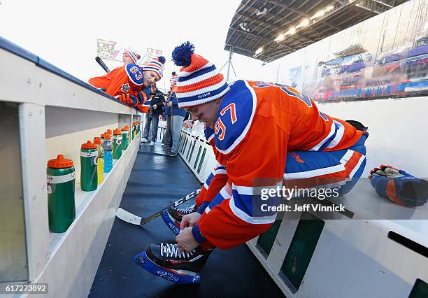 Connor McDavid of the Edmonton Oilers laces up before practice in advance of the 2016 Tim Hortons NHL Heritage Classic at Investors Group Field on...