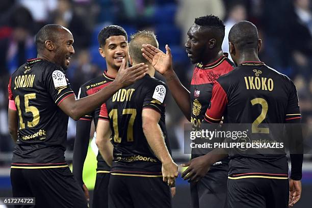 Guimgamp's players celebrates after winning the French L1 football match between Olympique Lyonnais and EA Guingamp on October 22 at the Parc...