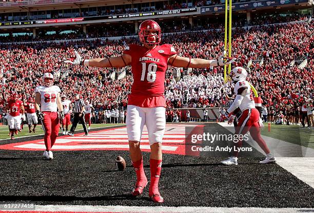Cole Hikutini of the Louisville Cardinals celebrates after scoring a touchdown during the game against the North Carolina State Wolfpack at Papa...