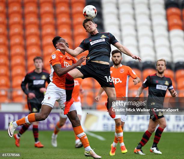 Blackpool's Jamille Matt jumps with Doncaster Rovers' Jordan Houghton during the Sky Bet League Two match between Blackpool and Doncaster Rovers at...