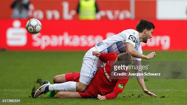 Dustin Bomheur of Duisburg tackles Tommy Grupe of Rostock during the third league match between MSV Duisburg and Hansa Rostock at...
