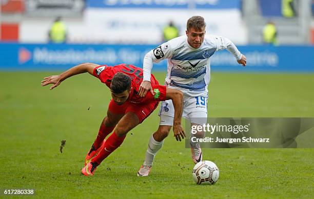 Nico Klotz of Duisburg tackles Kerem Buelbuel of Rostock during the third league match between MSV Duisburg and Hansa Rostock at...