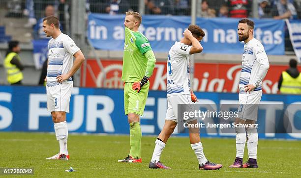 Players of Duisburg stand on the pitch LtoR Thomas Broeker, goalkeeper Mark Flekken, Ahmet Engin and Fabian Schnellhardt after the third league match...