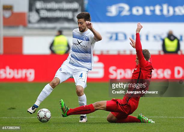 Tommy Grupe of Rostock tackles Dustin Bomheur of Duisburg during the third league match between MSV Duisburg and Hansa Rostock at...