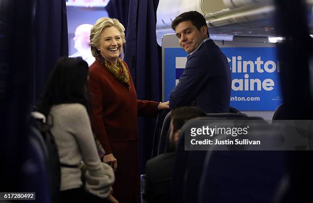 Democratic preisdential nominee former Secretary of State Hillary Clinton talks with traveling press secretary Nick Merrill aboard her campaign plane...