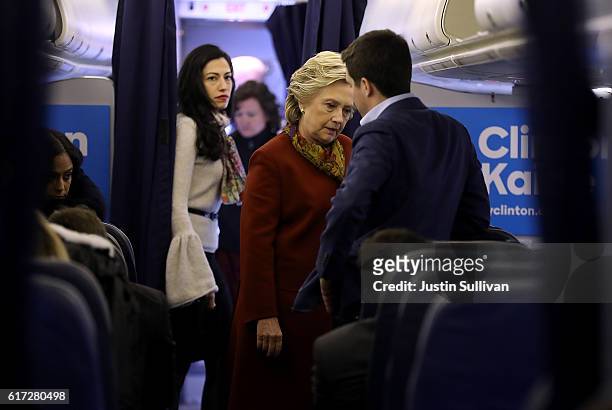Democratic preisdential nominee former Secretary of State Hillary Clinton talks with traveling press secretary Nick Merrill aboard her campaign plane...