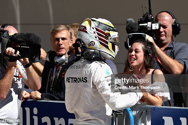 Lewis Hamilton of Great Britain and Mercedes GP celebrates qualifying in pole position with actor Rosa Salazer in parc ferme during qualifying for...