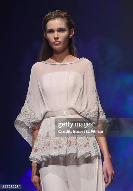 Model walks the runway during the Zareena show at Fashion Forward Spring/Summer 2017 held at the Dubai Design District on October 22, 2016 in Dubai,...
