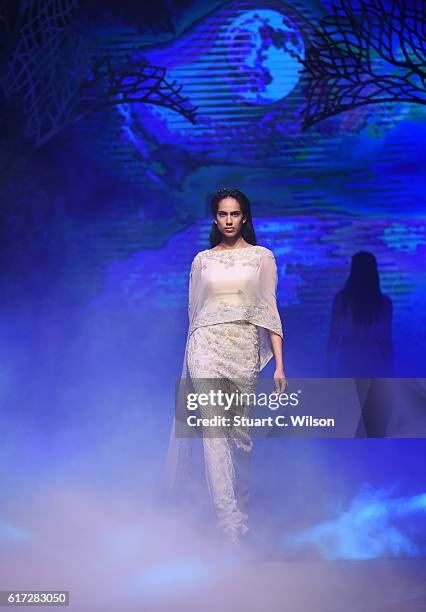 Model walks the runway during the Zareena show at Fashion Forward Spring/Summer 2017 held at the Dubai Design District on October 22, 2016 in Dubai,...