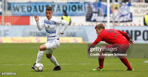 Fabian Schnellhardt of Duisburg controls the ball near Tommy Grupe of Rostock during the third league match between MSV Duisburg and Hansa Rostock at...