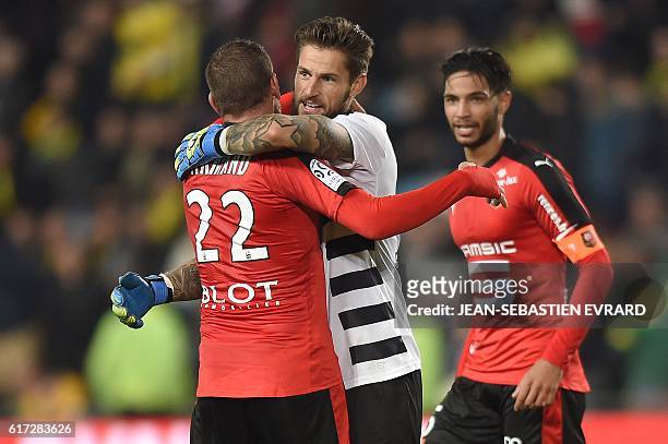 Rennes' French goalkeeper Benoit Costil celebrates with Rennes' French defender Sylvain Armand at the end of the French L1 football match between...