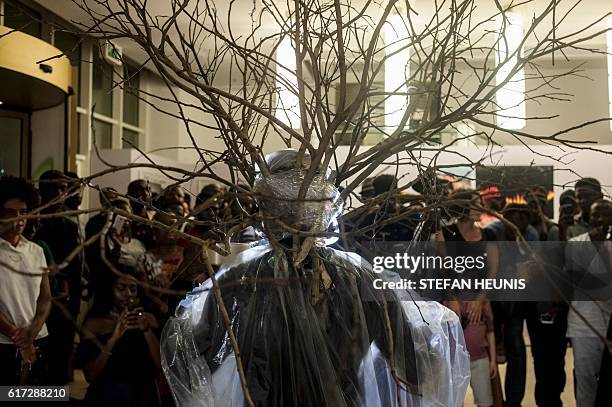 Artist Jelili Atiku performs during the opening of the Lagos Photo festival in Lagos on October 22, 2016. Lagos Photo was launched in 2010 and is the...