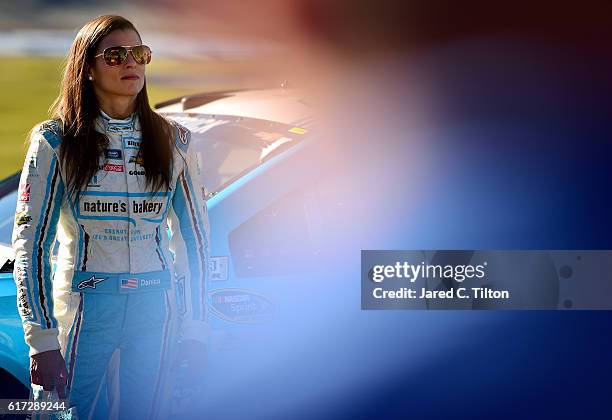 Danica Patrick, driver of the Nature's Bakery Chevrolet, stands on the grid during qualifying for the NASCAR Sprint Cup Series Hellmann's 500 at...