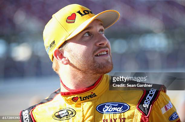 Chris Buescher, driver of the Love's Travel Stops Ford, stands on the grid during qualifying for the NASCAR Sprint Cup Series Hellmann's 500 at...