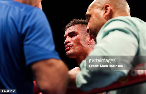Anthony Ogogo Of England is puled out by his trainer Tony Sims during the 8th round against Craig Cunningham Of England during their WBC...