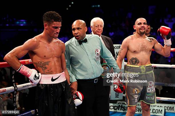 Referee Ian John Lewis holds aloft Craig Cunningham Of England arm after he stopped Anthony Ogogo Of England in the 8th Round during their WBC...